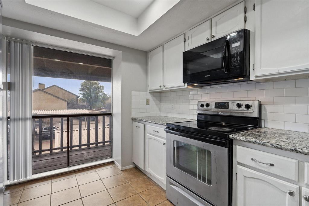 4533 North O'Connor Road, Unit 2208 Irving, TX 75062 - Photo 9 of 28 a kitchen with stainless steel appliances a stove a microwave and cabinets