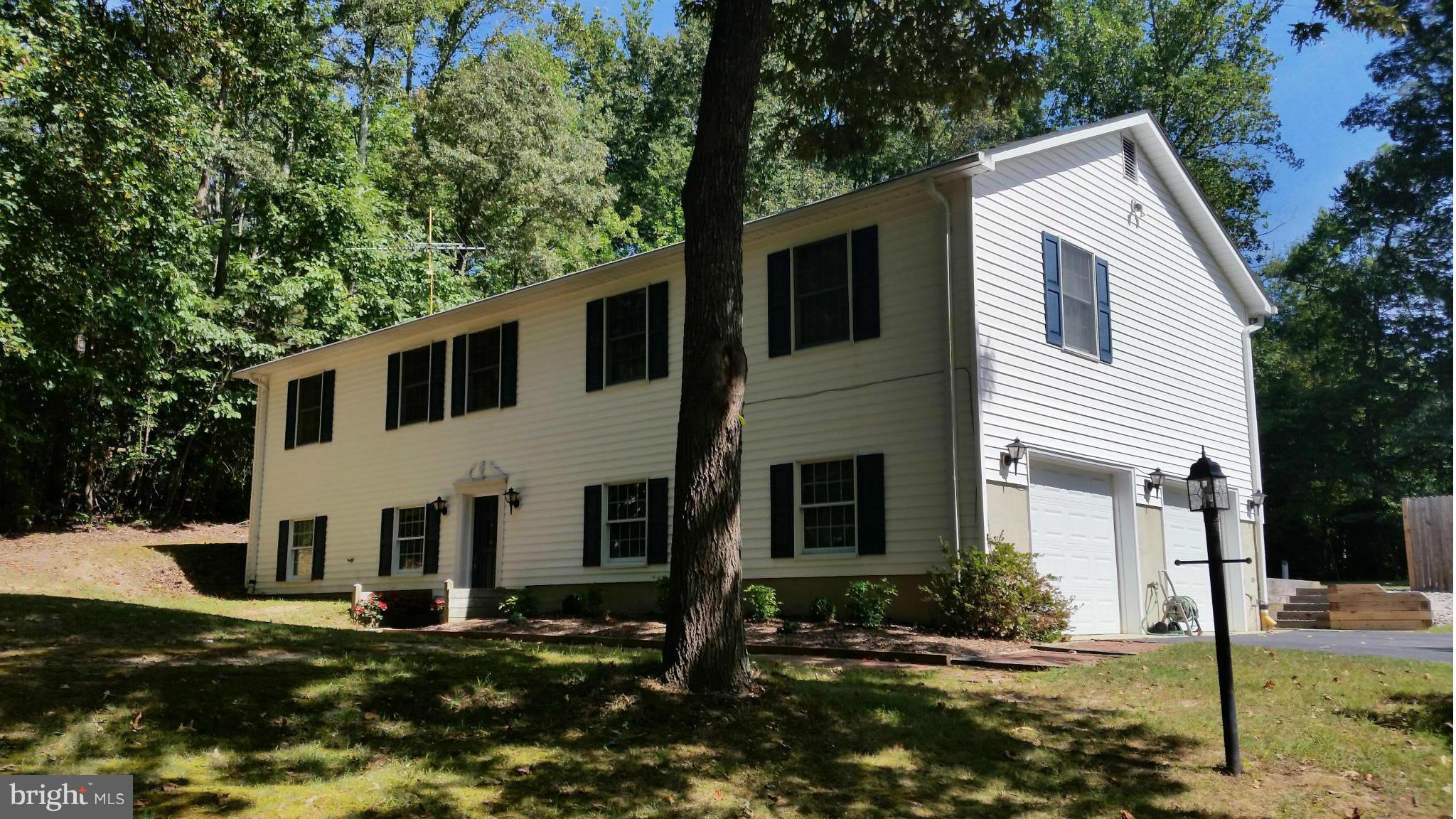 11030 Mill Bridge Road Lusby, MD 20657 - Photo 2 of 30 a front view of a house with garden