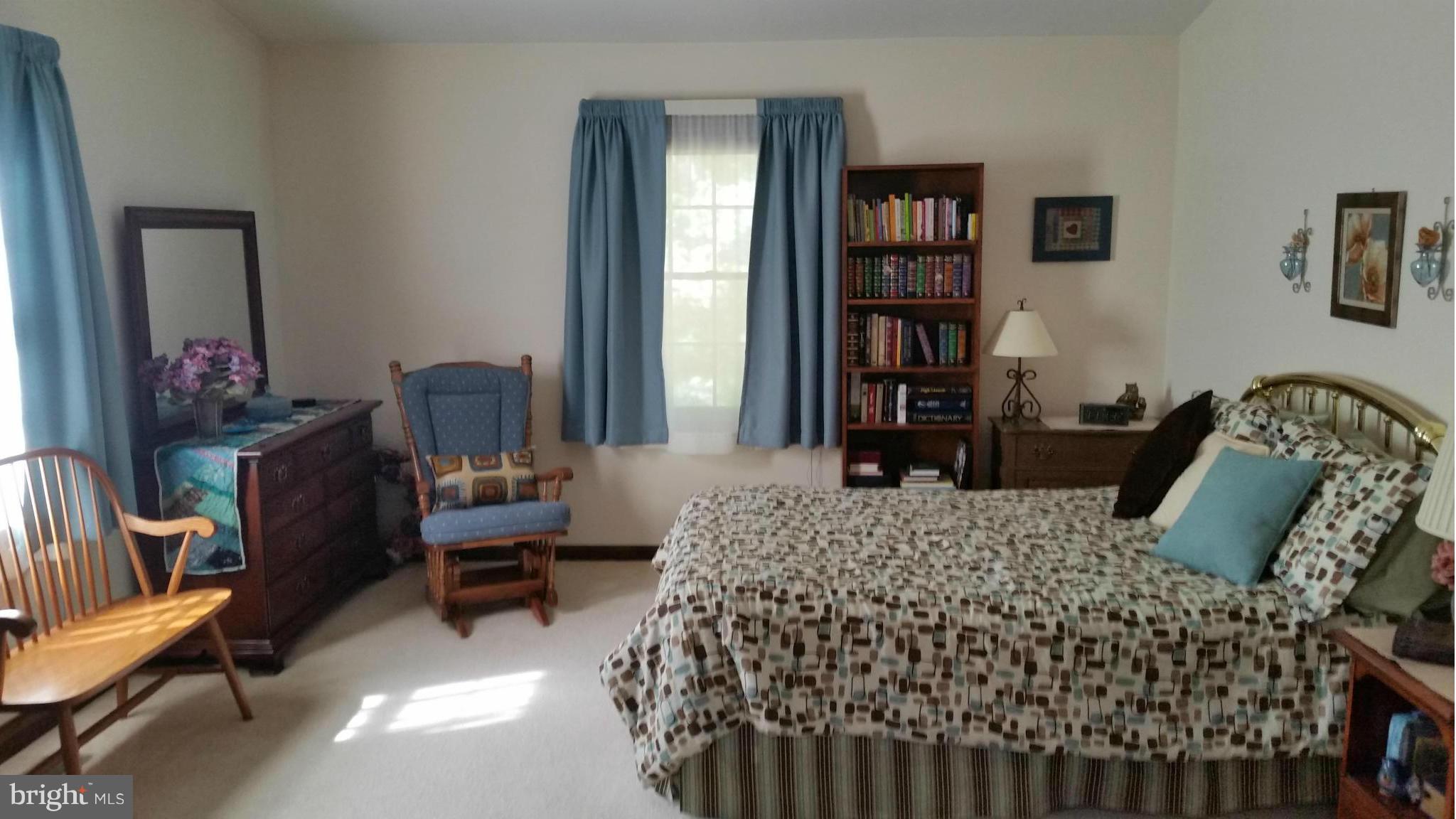 11030 Mill Bridge Road Lusby, MD 20657 - Photo 13 of 30 a bedroom with a bed furniture and book shelf