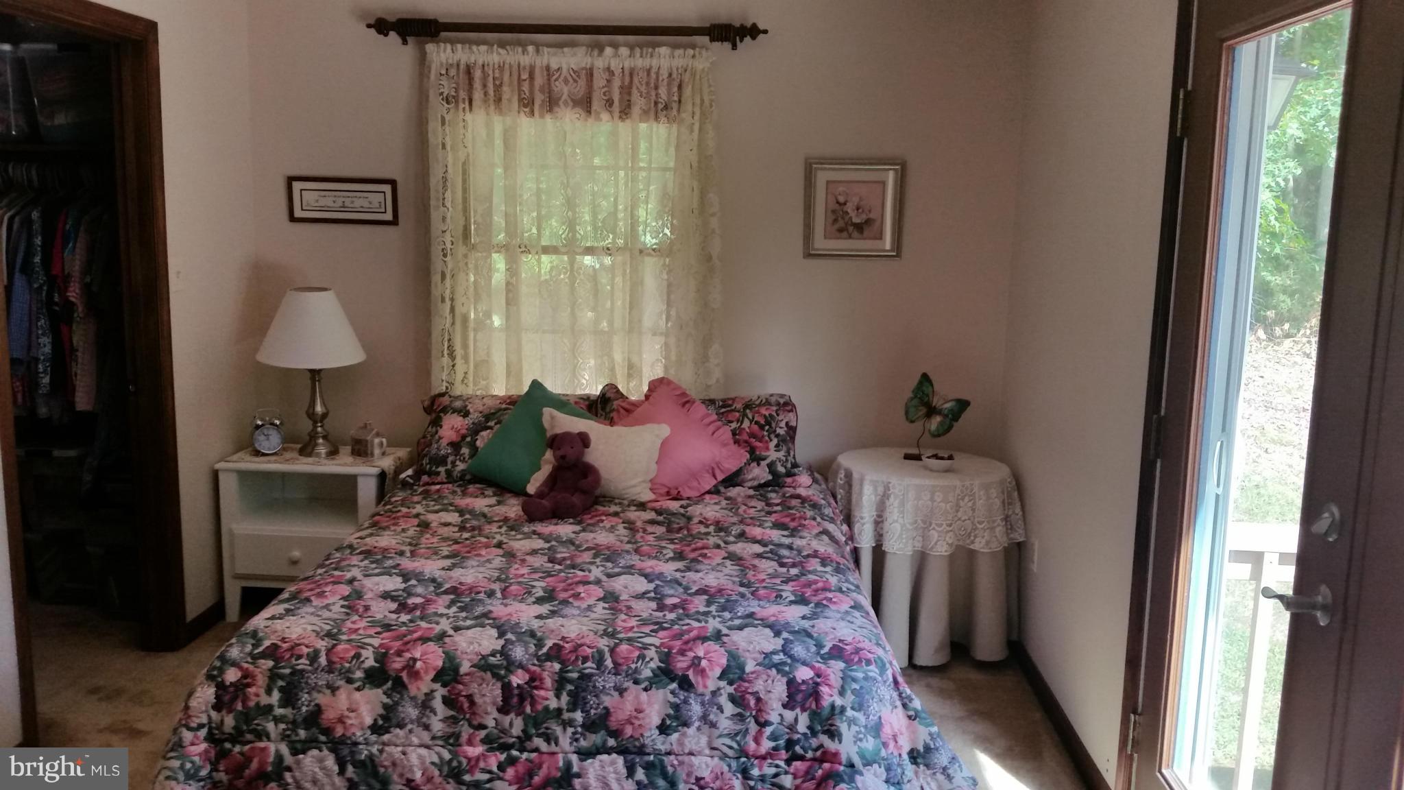 11030 Mill Bridge Road Lusby, MD 20657 - Photo 17 of 30 a bed room with a bed and a window