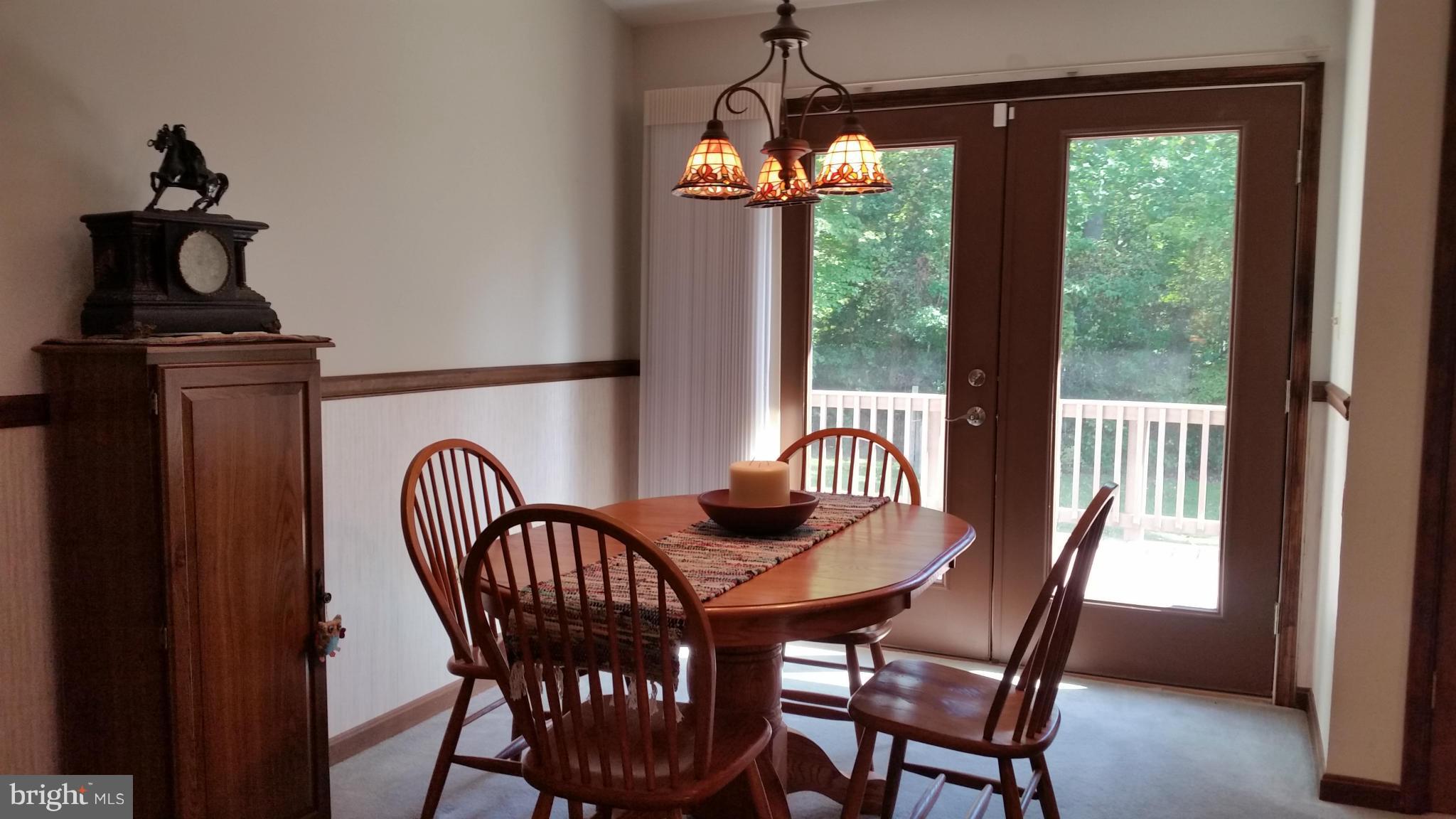 11030 Mill Bridge Road Lusby, MD 20657 - Photo 8 of 30 a view of a dining room with furniture window and outside view