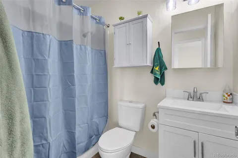 a roof deck with table and chairs and potted plants
