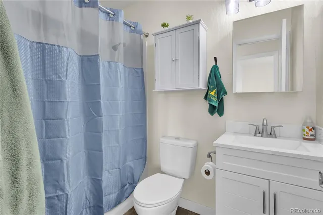 a roof deck with table and chairs and potted plants