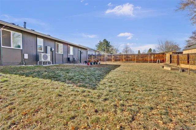 a view of a backyard with table and chairs