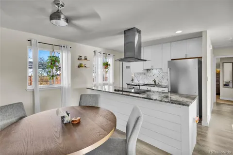 a view of a dining room with furniture and a potted plant