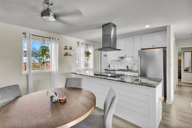 a view of a dining room with furniture and a potted plant