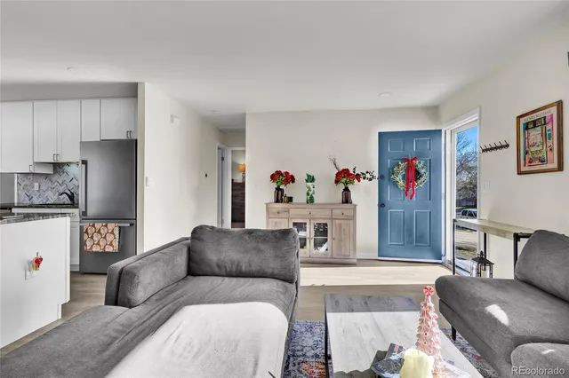 a living room with furniture and a potted plant