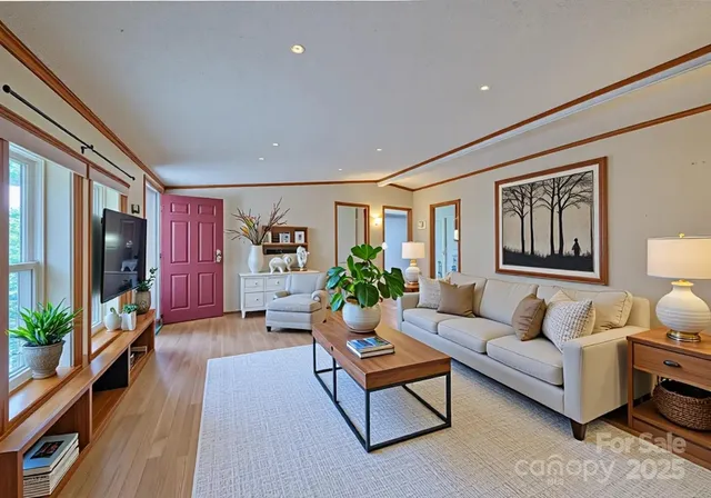 a living room with furniture and wooden floor