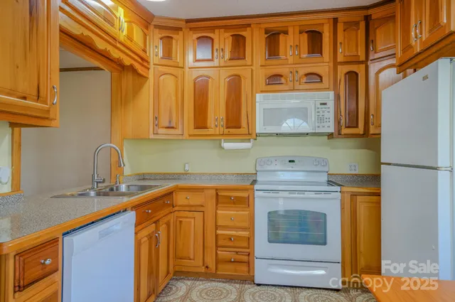 a kitchen with stainless steel appliances granite countertop a stove and a sink