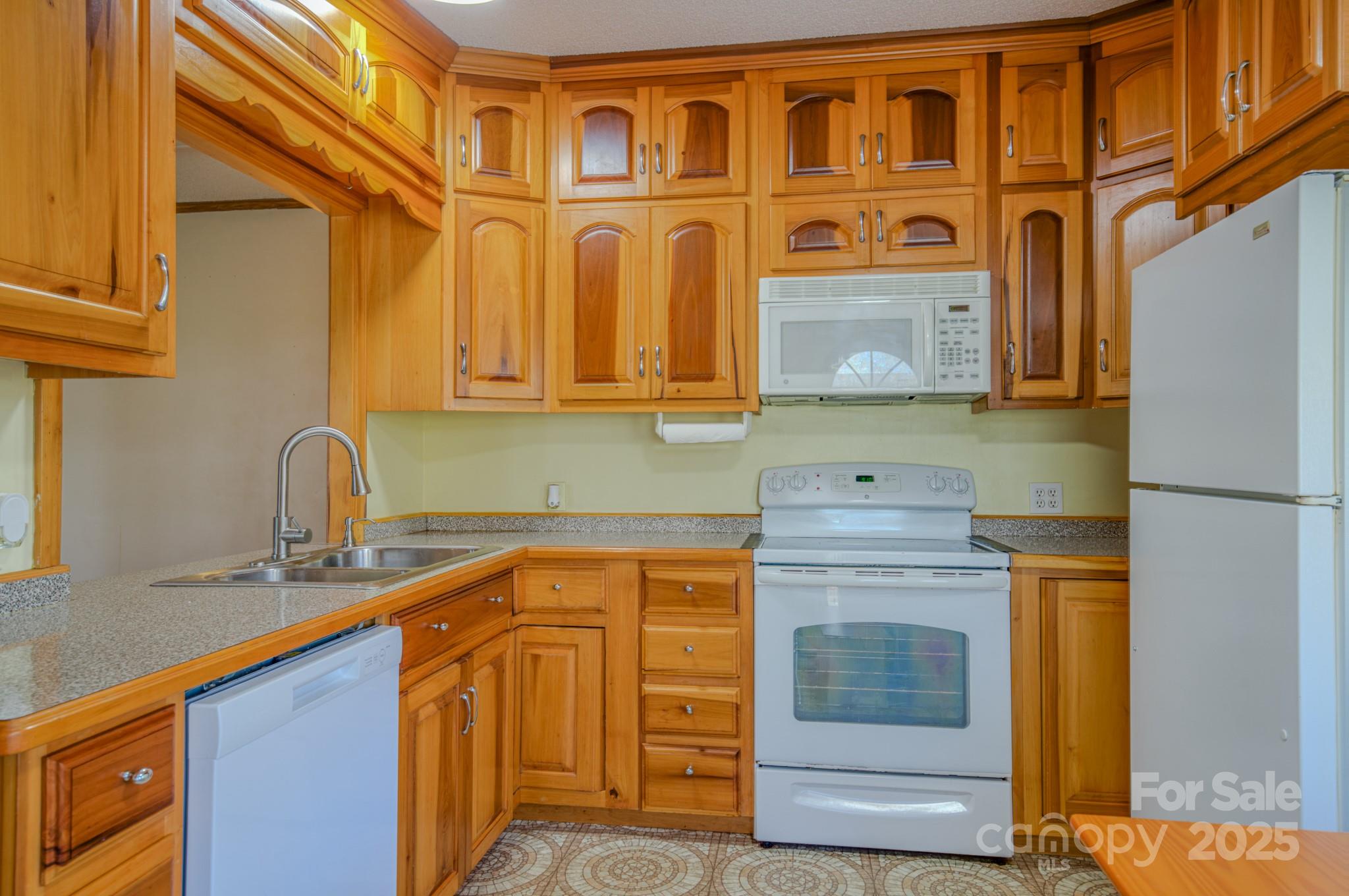 319 Sunrise Ridge Drive, Unit 19 Hendersonville, NC 28792 - Photo 6 of 30 a kitchen with stainless steel appliances granite countertop a stove and a sink