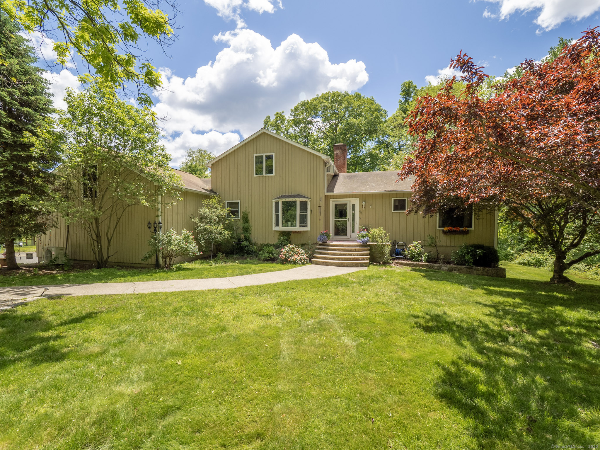 a front view of house with yard and trees