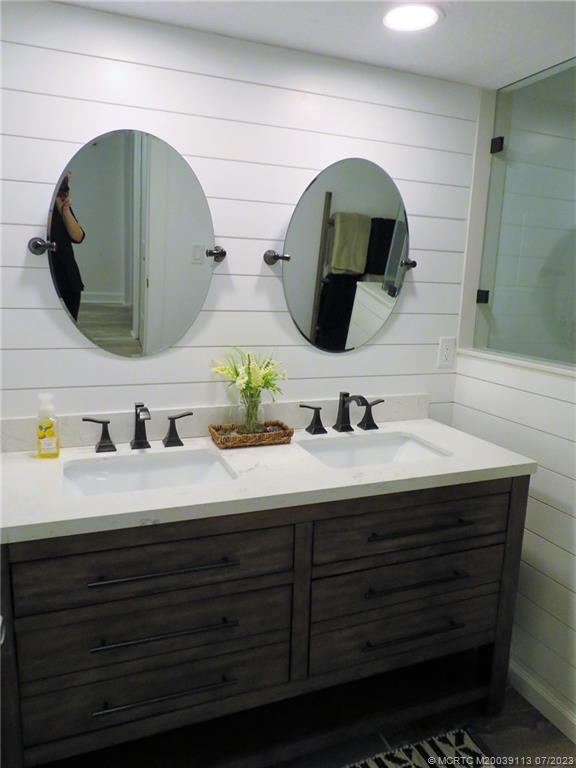800 Northwest Fork Road, Unit 4 Stuart, FL 34994 - Photo 19 of 31 a bathroom with a double vanity sink and mirror