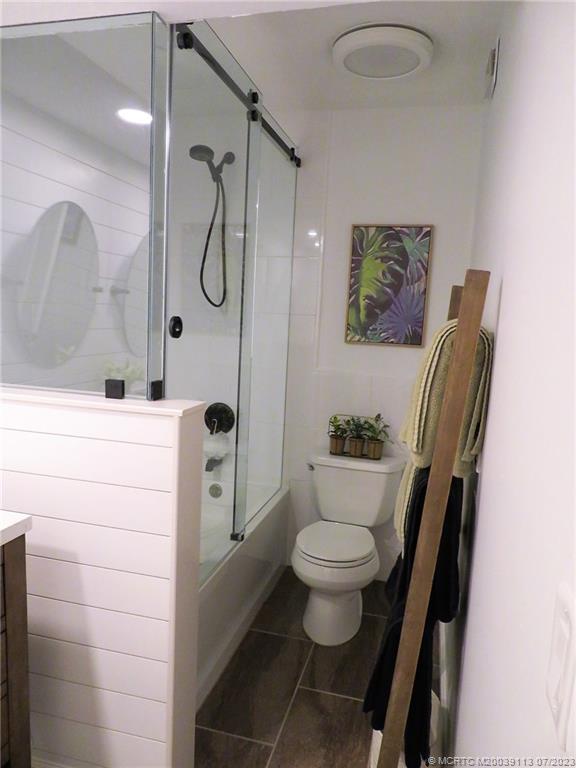 800 Northwest Fork Road, Unit 4 Stuart, FL 34994 - Photo 20 of 31 a bathroom with a granite countertop sink toilet and shower