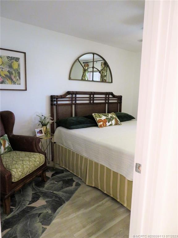 800 Northwest Fork Road, Unit 4 Stuart, FL 34994 - Photo 24 of 31 a bedroom with a bed and a dresser