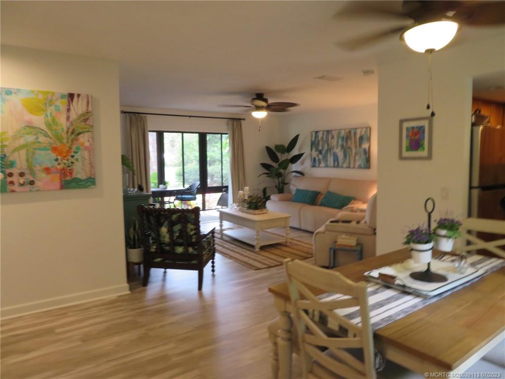 800 Northwest Fork Road, Unit 4 Stuart, FL 34994 - Photo 4 of 31 a living room with fireplace furniture and a wooden floor