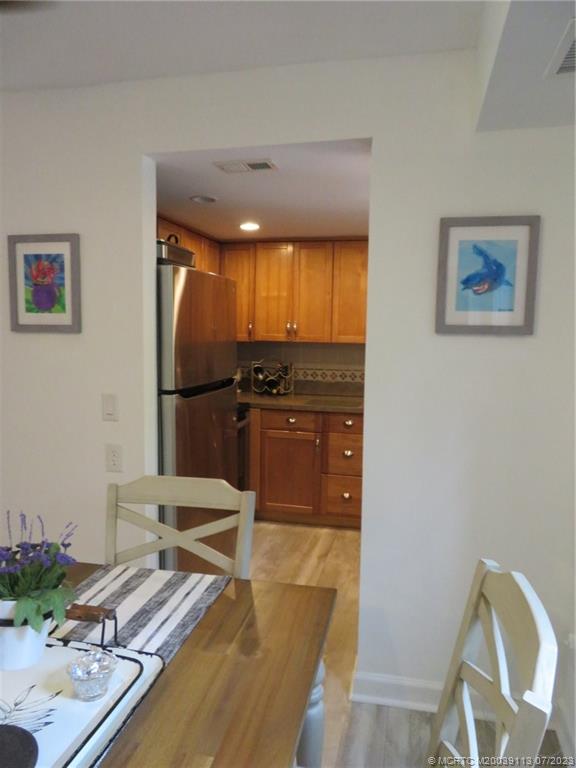 800 Northwest Fork Road, Unit 4 Stuart, FL 34994 - Photo 6 of 31 a living room with furniture and a flat screen tv