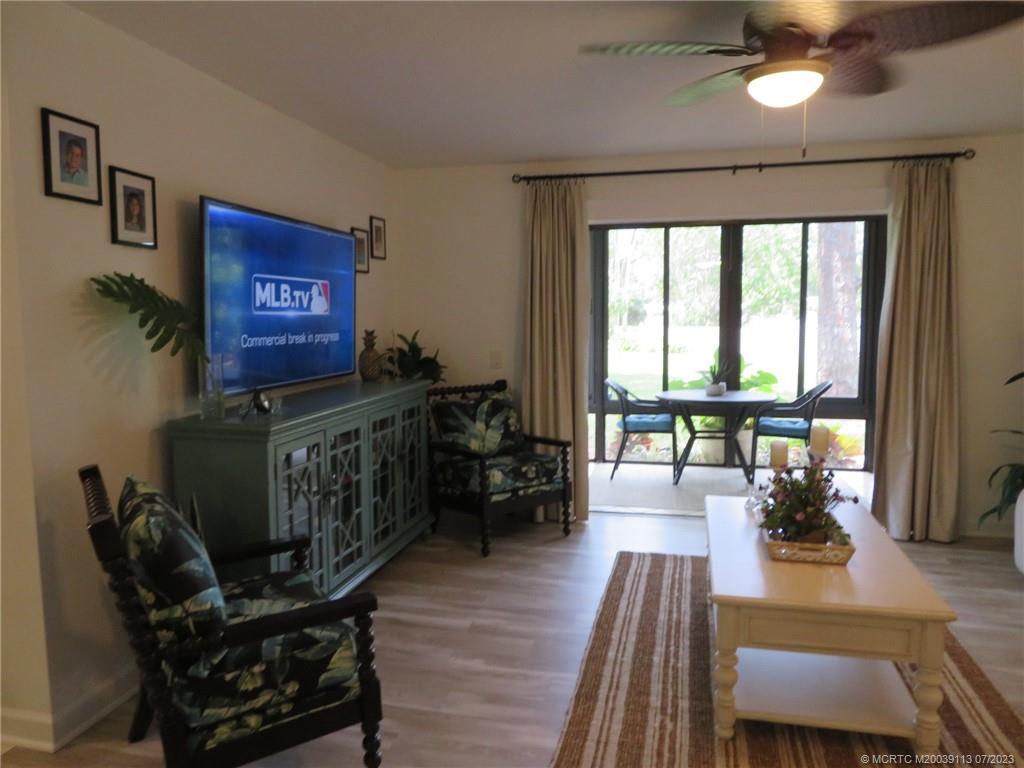 800 Northwest Fork Road, Unit 4 Stuart, FL 34994 - Photo 7 of 31 a living room with furniture and a wooden floor