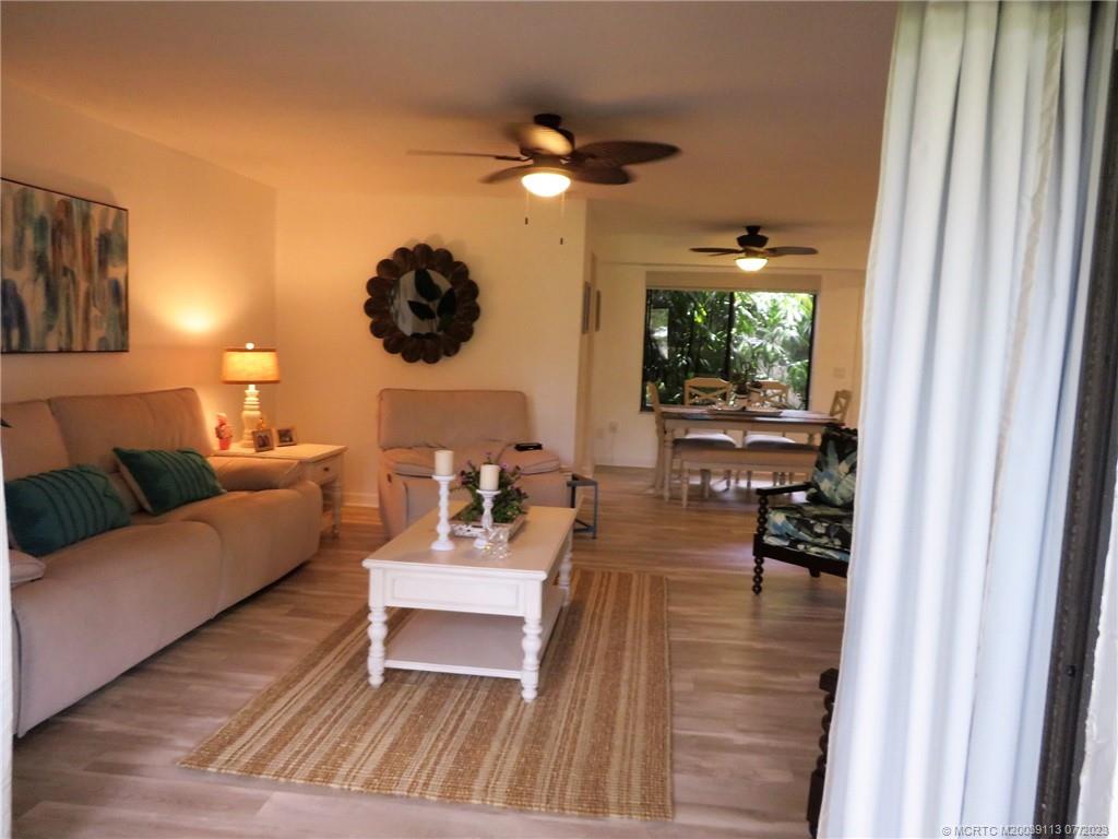 800 Northwest Fork Road, Unit 4 Stuart, FL 34994 - Photo 8 of 31 a living room with furniture and a flat screen tv
