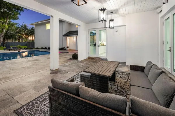 a living room with furniture and a chandelier