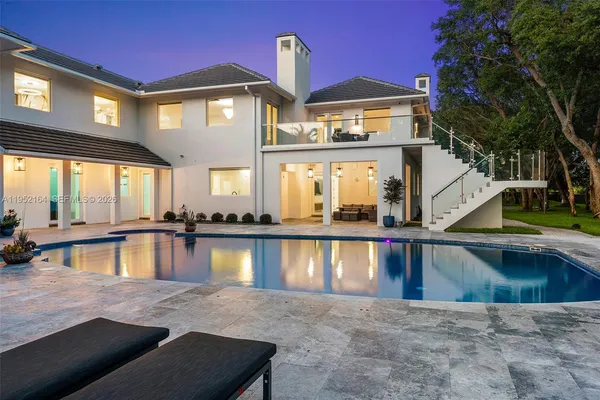 a view of a house with pool and a lake view