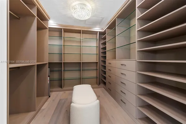 a view of walk in closet with empty racks