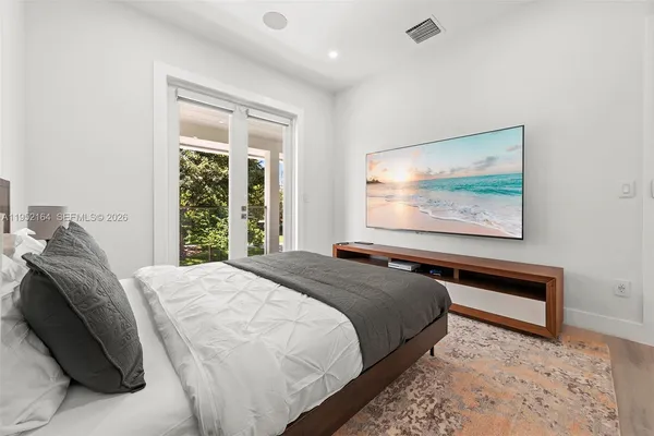 a bedroom with a bed and a painting on the wall