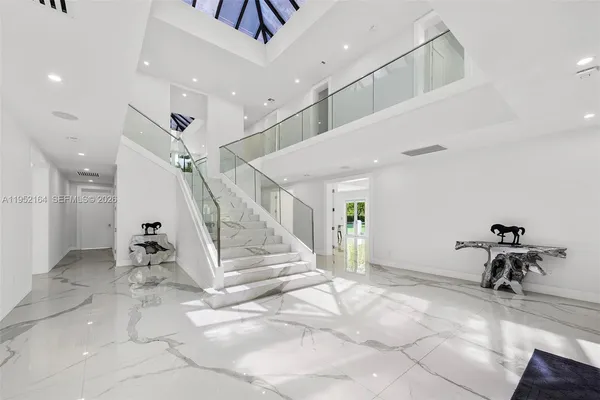 a view of entryway and hall with a view of living room