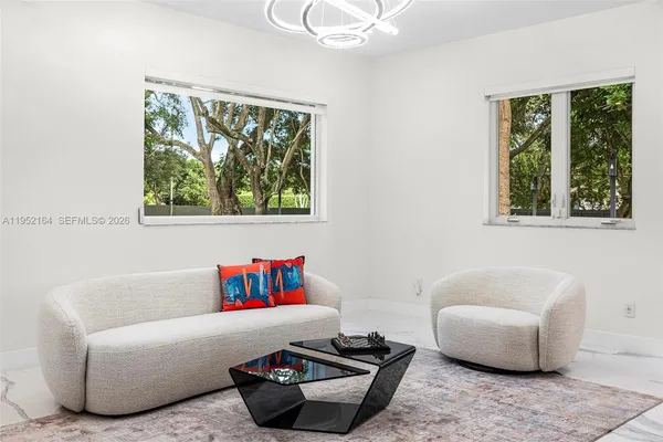a living room with furniture and a window