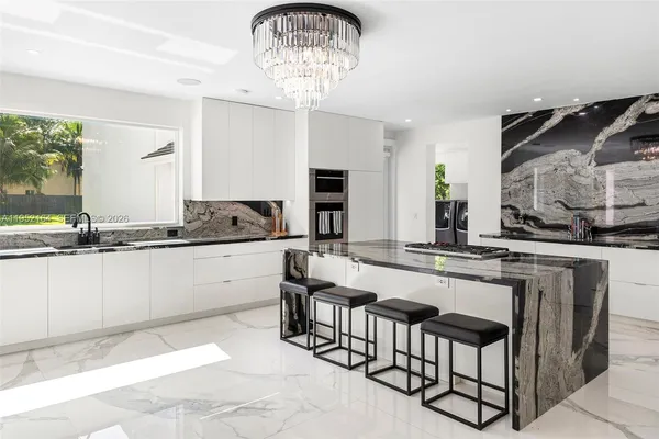 a kitchen with granite countertop stainless steel appliances a sink and a stove