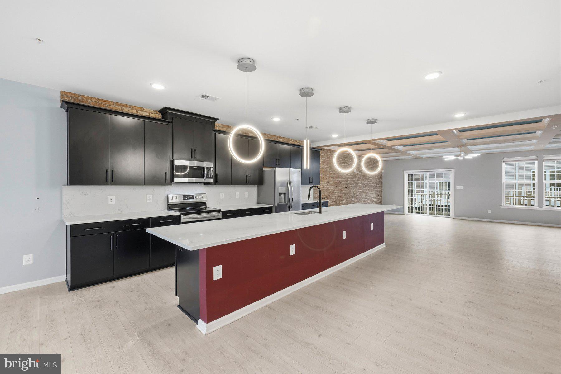 2917 Duvall Ridge Road, Unit 559 Hyattsville, MD 20785 - Photo 11 of 31 a large kitchen with stainless steel appliances a large counter top a stove and a sink