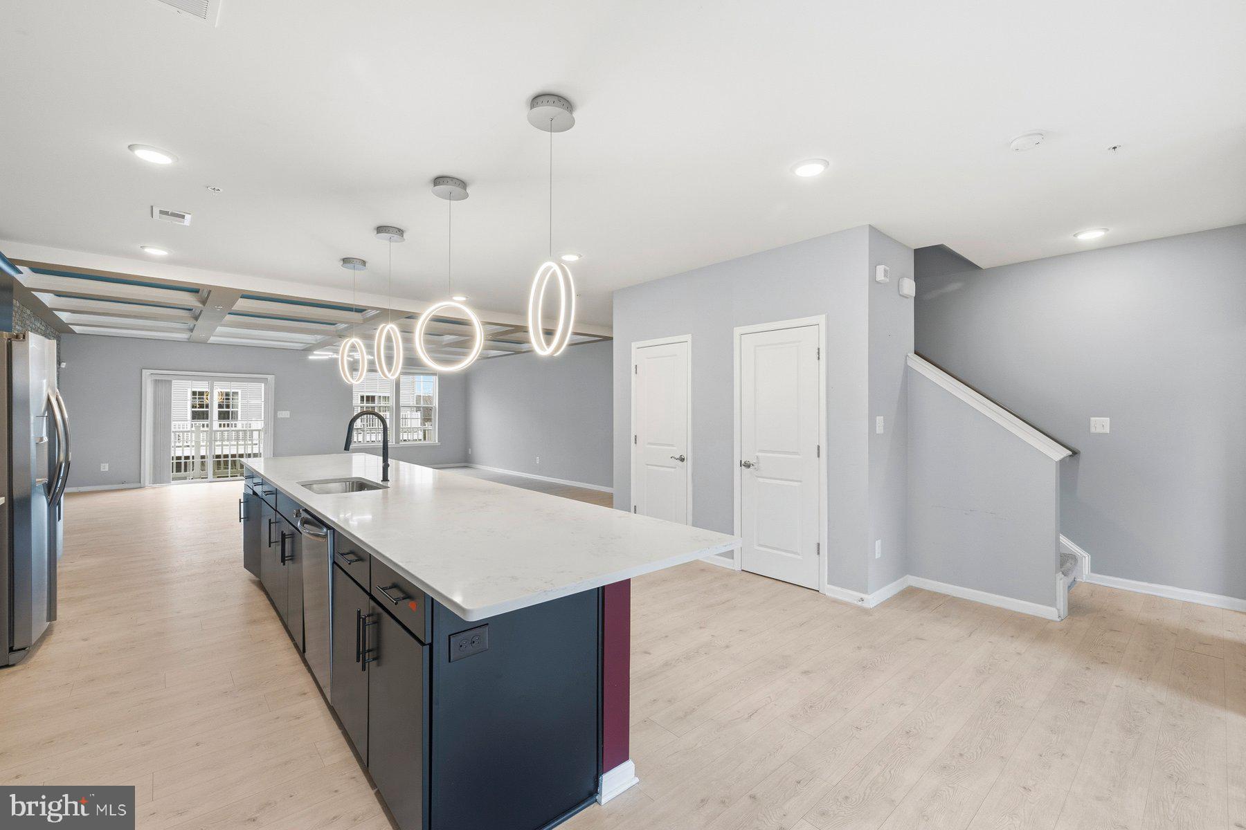 2917 Duvall Ridge Road, Unit 559 Hyattsville, MD 20785 - Photo 12 of 31 a large kitchen with kitchen island a sink a counter space and stainless steel appliances