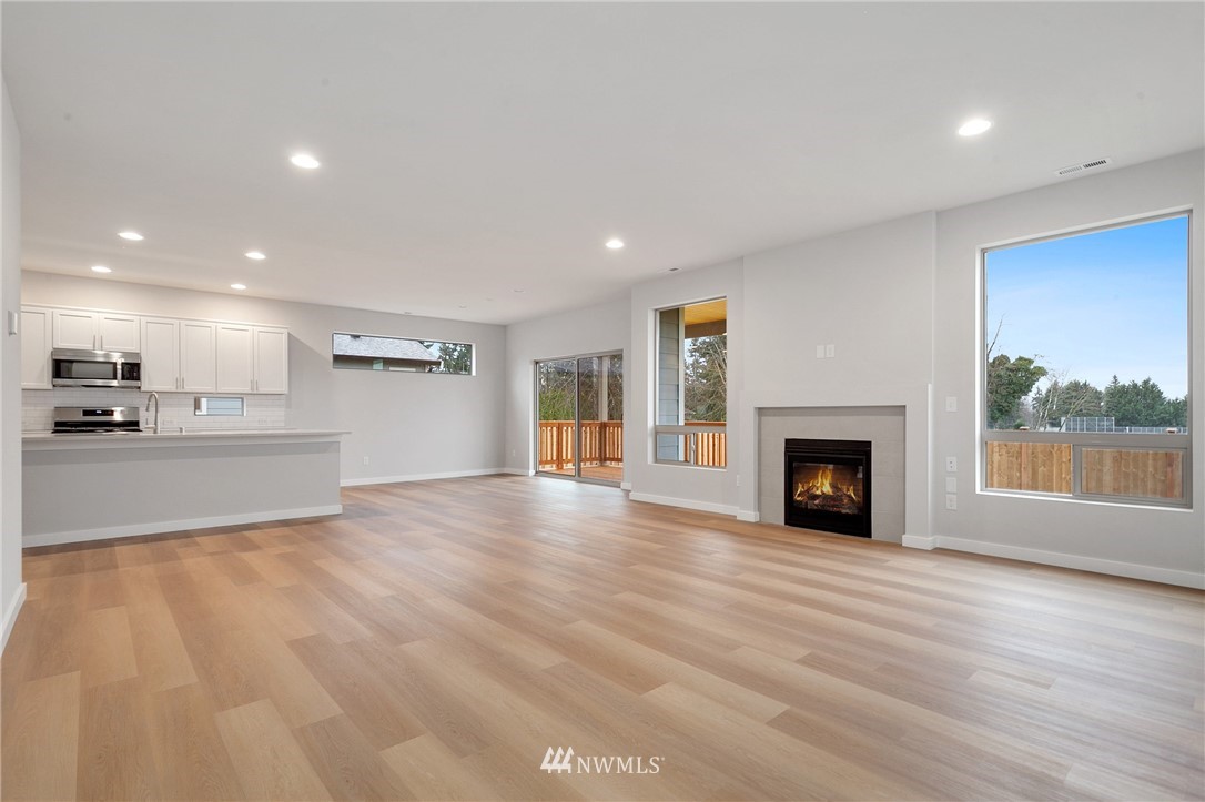 1630 Gault Street, Unit 6 Sumner, WA 98390 - Photo 8 of 24 a view of an empty room with a fireplace and a window