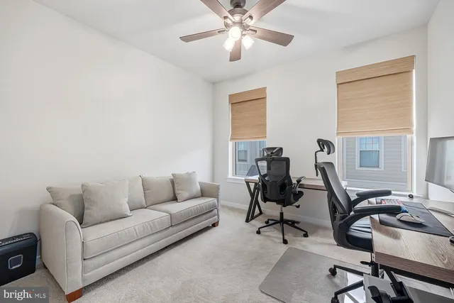 a view of a livingroom with workspace and a couch