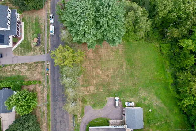 an aerial view of a house with a yard