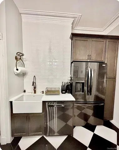 a kitchen with a sink appliances and cabinets