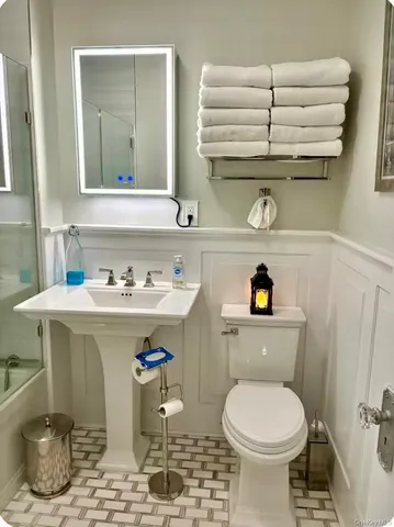 a bathroom with a sink a toilet and vanity