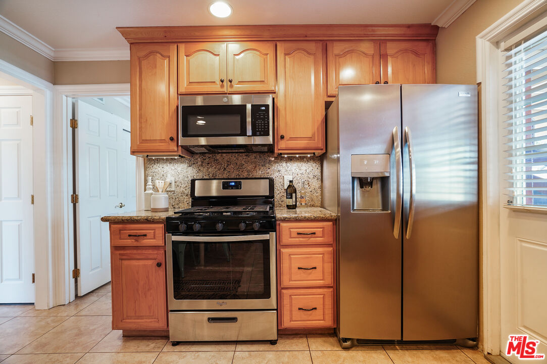 1043 Appleton Road Simi Valley, CA 93065 - Photo 11 of 53 a kitchen with stainless steel appliances granite countertop a refrigerator and a stove
