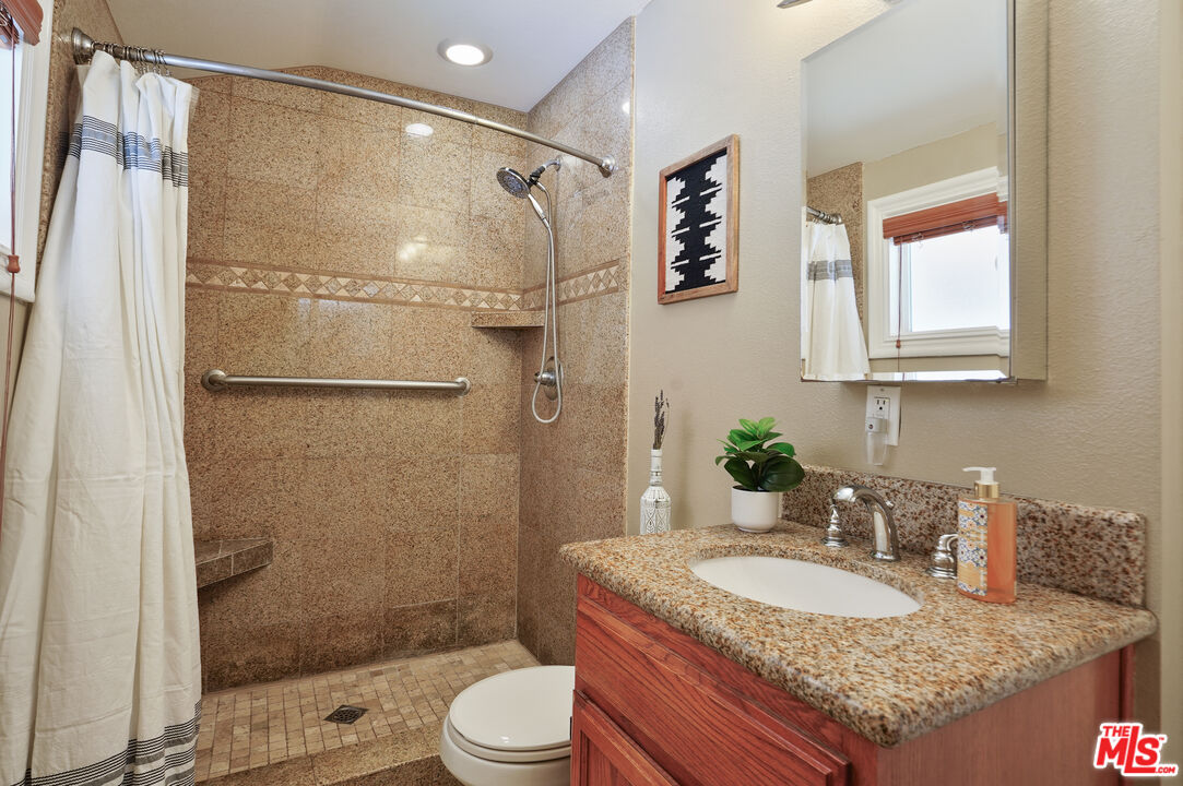 1043 Appleton Road Simi Valley, CA 93065 - Photo 18 of 53 a bathroom with a granite countertop sink toilet and shower