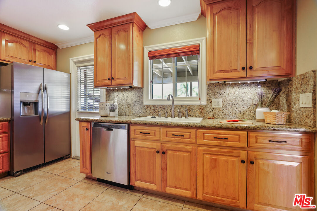 1043 Appleton Road Simi Valley, CA 93065 - Photo 10 of 53 a kitchen with stainless steel appliances granite countertop a refrigerator and cabinets