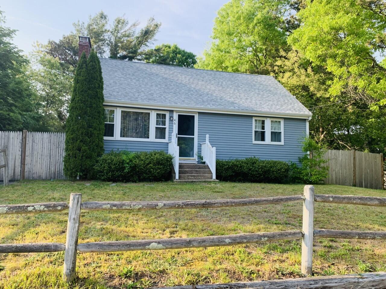 a view of a house with swimming pool next to a yard