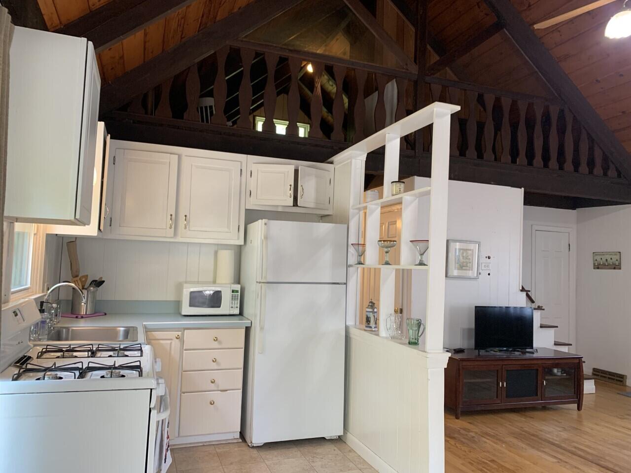 46 Williams Avenue Pocasset, MA 02559 - Photo 18 of 26 a kitchen with appliances a refrigerator and cabinets