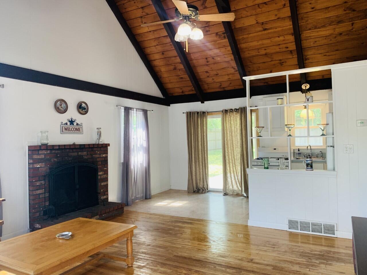 46 Williams Avenue Pocasset, MA 02559 - Photo 4 of 26 a view of an empty room with wooden floor and a fireplace