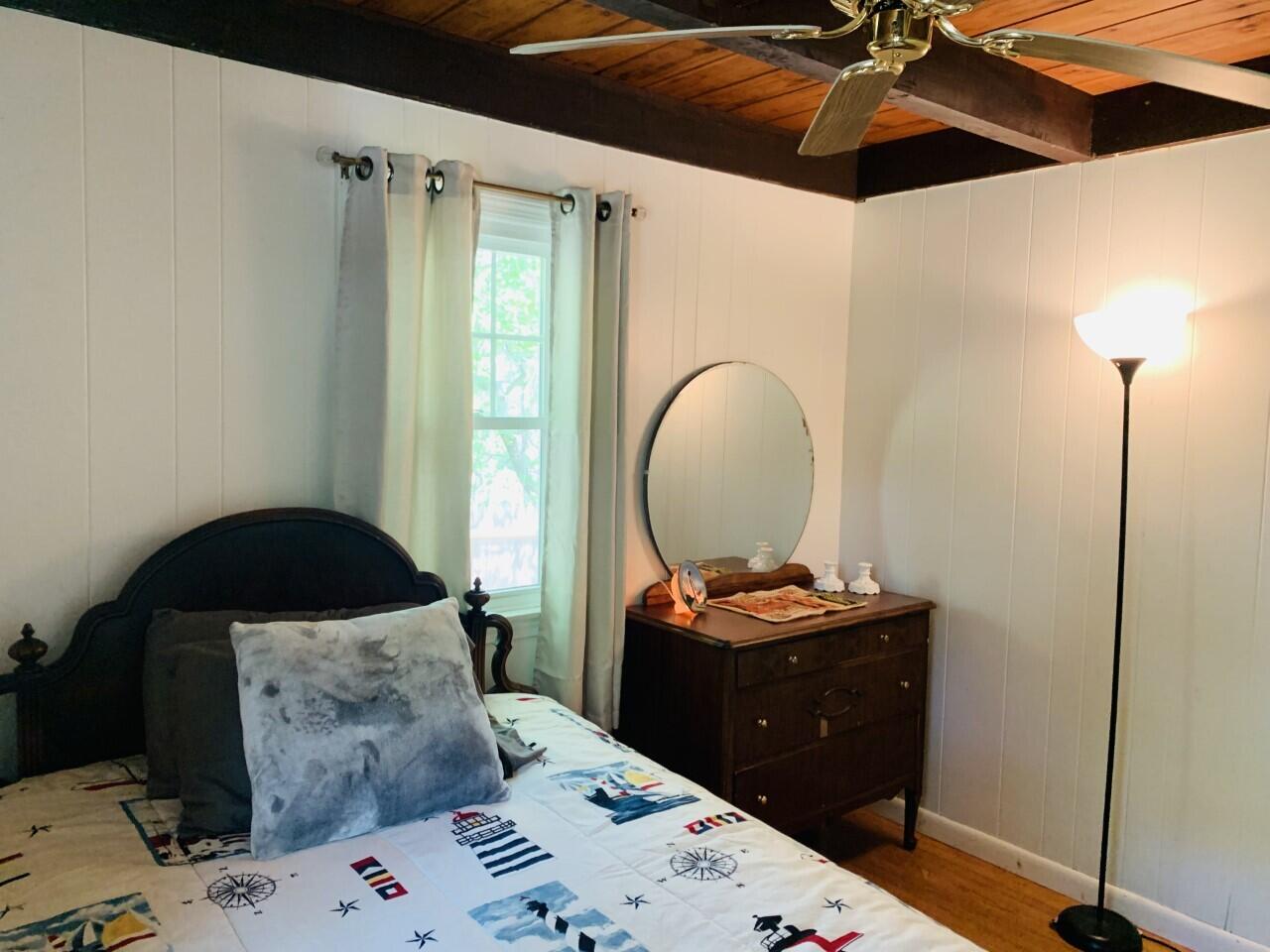 46 Williams Avenue Pocasset, MA 02559 - Photo 7 of 26 a bedroom with a bed and a lamp