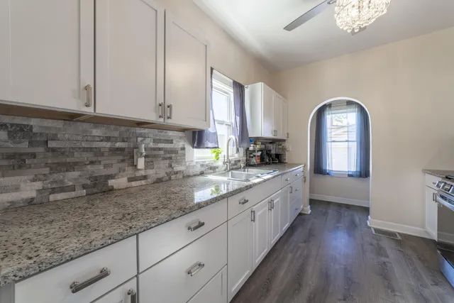 a kitchen with a sink a counter top space and a window