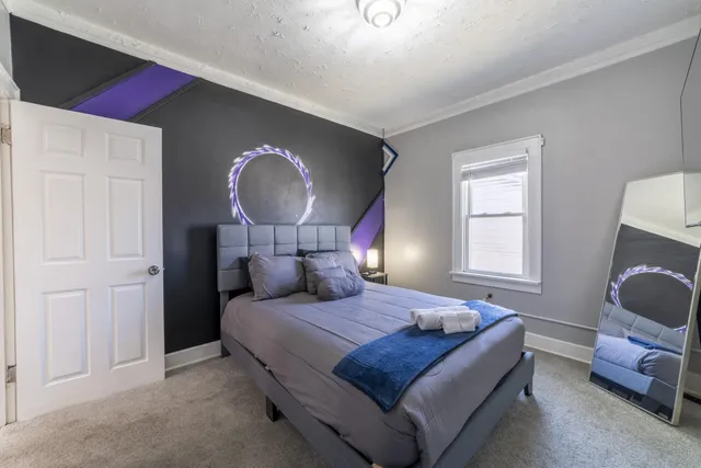 a bedroom with a bed and a window