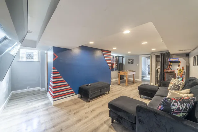 a bedroom with two beds and a book shelf