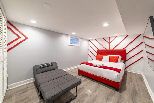 a bedroom with a bed and a flat screen tv