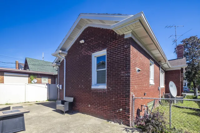 a aerial view of a house with garden space and street view