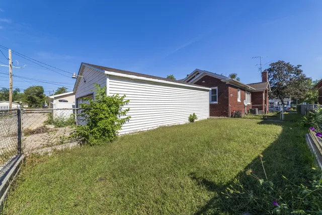 an aerial view of a houses with street