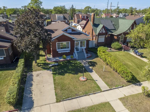 an aerial view of residential houses with outdoor space